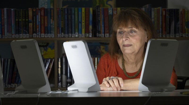 Claire Charlwood is pictured using one of the SAD lamps at the William Patrick Library in Kirkintilloch.