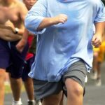 Participants run up a hill during morning exercise